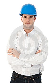 Goodlooking young architect standing arms crossed