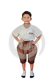 Goodly Asian boy age about 6 years old wearing traditional Thai dress with stand akimbo gesture isolated on white background.