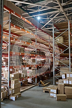 Goods in cardboard boxes on the warehouse shelves