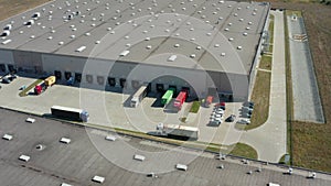 Goods distribution warehouse. Semitrailers load cargo containers.