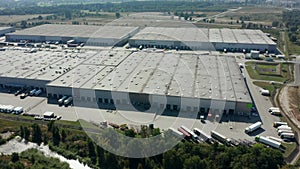 Goods distribution warehouse. Semitrailers load cargo containers.