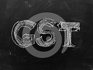 Goods & Services Tax - GST - Handwritten on Blackboard - Stock I