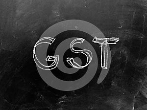 Goods & Services Tax - GST - Handwritten on Blackboard - Stock I
