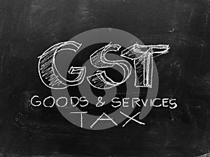 Goods & Services Tax - GST - Handwritten on Blackboard - Stock I