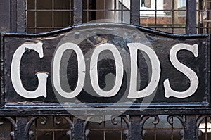 Goods sign close up on a metal gate