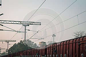 A goods train passing through railway station platform. Cargo train passing through a platform