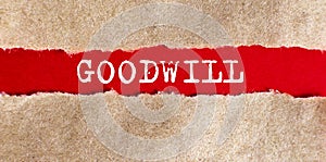 Goodwill text appearing behind on torn paper