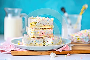 gooey marshmallow treat bars stacked high on a plate