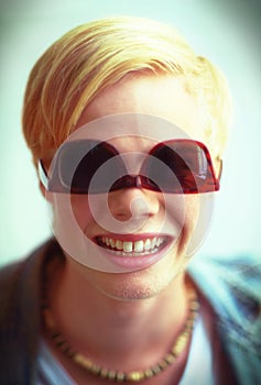 Goofy, cool and portrait of a man with sunglasses for fashion, streetwear and a teen trend. Happy, funny and face or a