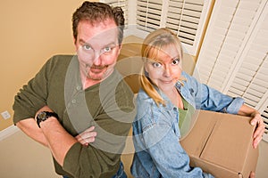 Goofy Couple and Moving Boxes in Empty Room photo