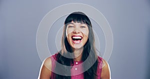 Goofy, face and woman laughing in a studio for funny, comic and silly joke or emoji. Smile, excited and portrait of