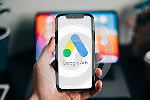 Google Ads logo on smartphone screen in hand