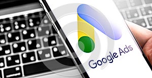 Google Ads symbol on the screen smartphone and notebook background