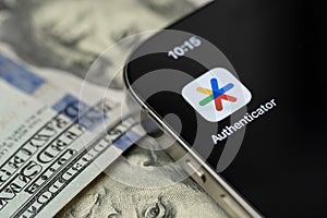 Google Authenticator app on smartphone screen with dollar background