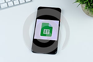 Google Sheets app logo on a smartphone screen.