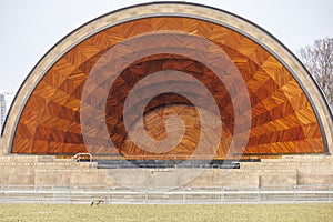 Goose eating grass in front of a outdoor theater