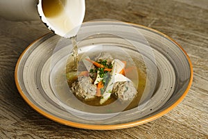 Goose soup, consomme with dumplings and vegetables