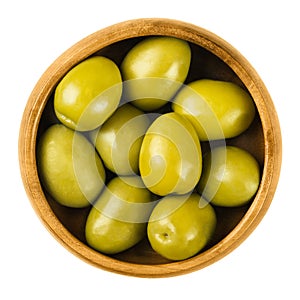 Gordal Reina green olives in a wooden bowl over white photo