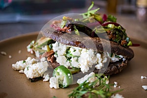 Gordita made with blue corn masa stuffed with chicharron short rib and cheese