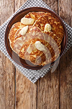 Gorditas de Azucar Sweet Griddle Cakes with butter close-up on a plate. Vertical top view