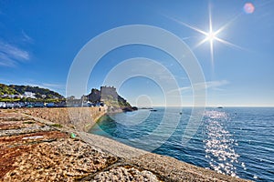 Gorey Harbour wall and Gorey Castle at sunrise