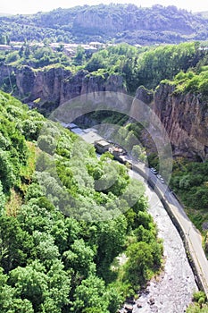 Gorge of the Arpa River. View of the mountains, the river, the road and the blue sky. The city of Jermuk, Armenia