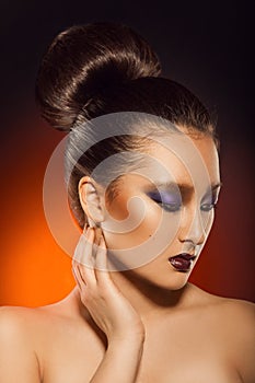 Gorgeous adult asuan woman looking away in studio photo