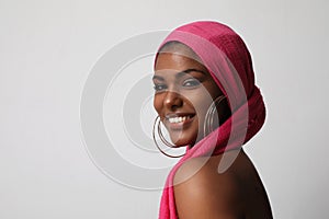 Gorgeous African American woman with traditional turban on white wall. Mock-up.