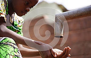 Gorgeous African Black Young Girl Washing Hands Outdoors with Freshwater