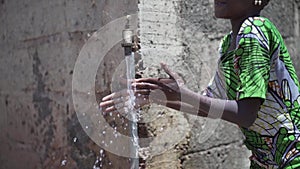 Gorgeous African Black Young Girl Washing Hands Outdoors with Freshwater