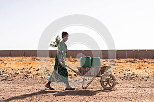 Gorgeous African ethnicity Girl Carrying fresh Water for an aridity concept photo