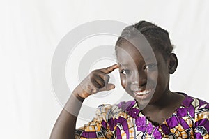 Gorgeous African girl pointing finger at her head, isolated on w