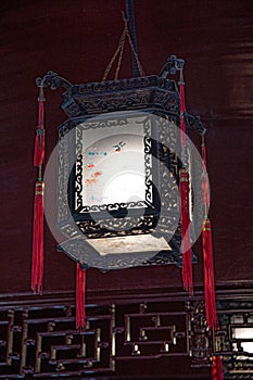 Gorgeous antique Chinese lantern with ornate lampshade and red tassels. Chandelier of ancient palace in Yu Yuan Garden of Shanghai