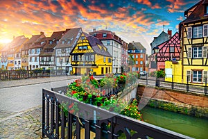 Gorgeous antique half-timbered facades with decorated street, Colmar, France