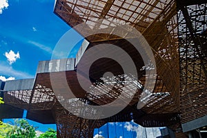 Gorgeous architectural woodden structure, with some vegetation behind, in a botanical greenhouse in Medellin