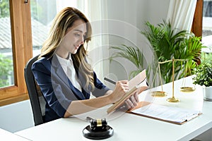 Gorgeous Asian female lawyer working at her office desk