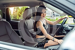 Gorgeous asian woman driving modern car