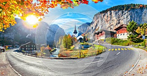 Gorgeous autumn landscape of  alpine village Lauterbrunnen with famous church and Staubbach waterfall