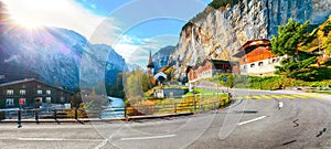 Gorgeous autumn landscape of  alpine village Lauterbrunnen with famous church and Staubbach waterfall
