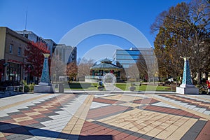 A gorgeous autumn landscape at the Decatur Square with red and yellow autumn trees, lush green trees and a round blue pergola photo