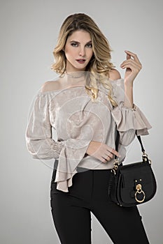 Gorgeous beautiful stylish woman posing in off white blouse