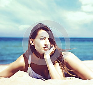 Gorgeous and beautiful young girl relaxing on a summer beach