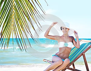 Gorgeous and beautiful young girl relaxing on a summer beach