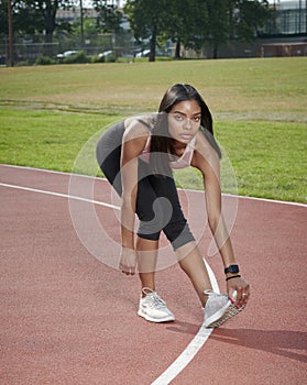 Gorgeous black female fitness model outside on track