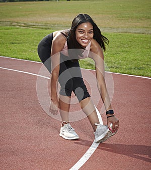 Gorgeous black female fitness model outside on track