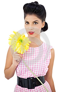 Gorgeous black hair model holding a flower