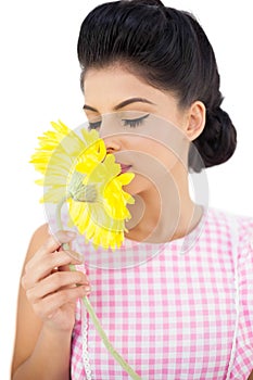 Gorgeous black hair model smelling a flower