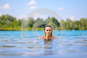 Gorgeous blond woman rising out of the water