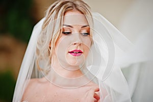 Gorgeous blonde bride with long veil