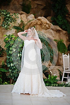 Gorgeous blonde bride with long veil